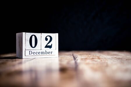 December 2nd, 2 December, Second of December - White block calendar on vintage table - Date on dark backgroundの写真素材