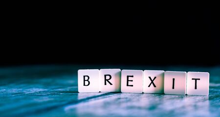 Brexit word made of tiles on dark wooden backgroundの写真素材