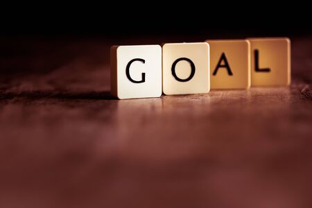 Goal word made of tiles on dark wooden backgroundの写真素材