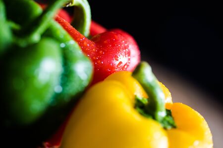 Close up of yellow, green and red capsicumsの写真素材