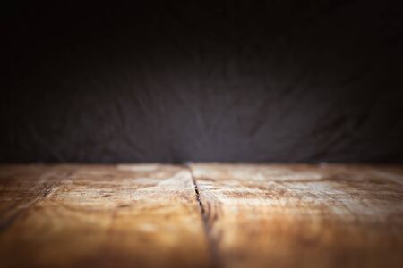 Dark background and vintage wooden table in the foregroundの写真素材