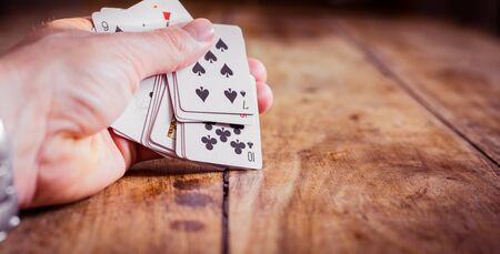 Combination of Playing Cards | Poker Face | Hand holding Cards | Games and Gamblingの写真素材