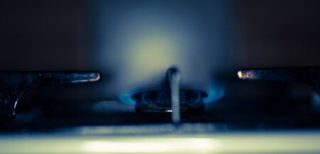 Blurred gas hob and blue flame in the old fashioned kitchenの写真素材