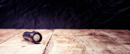 Small pocket LED torch isolated on wooden tableの写真素材