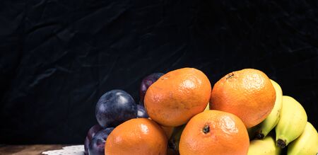 Fresh fruit selection against dark backgroundの写真素材