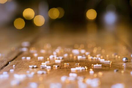 Christmas glowing Golden Background. Christmas lights. Gold Holiday New year Abstract Glitter Defocused Background With Blinking Stars and sparks. Blurred Bokeh.の写真素材