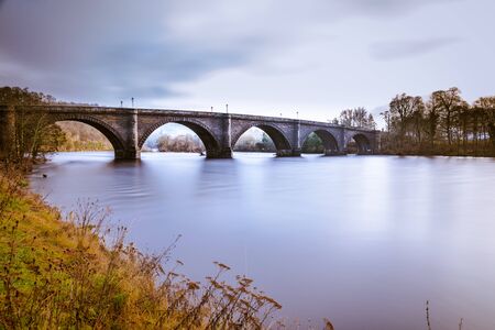 Dunkeld bridge over the river Tay in Perthshire, Scotland. Telford's famous bridge over the mighty River Tay, Dunkeld, Perth & Kinross, Scotland, Europe.の写真素材