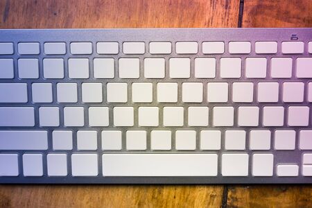 Silver computer keyboard with blank buttons. Vintage style image