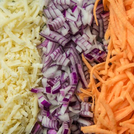 Healthy food concept. Vegetables: carrots, onions, turnip. Grated vegetable close up in the kitchen. Food concept.の写真素材
