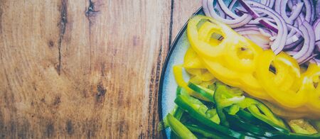 Meal for vegan concept. Sliced vegetables on a plate on a wooden table.の写真素材