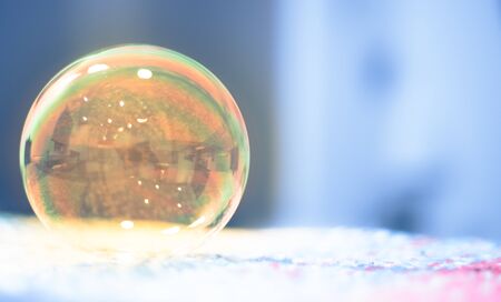 Soap bubbles floating in the air as the Summer sun setsの写真素材