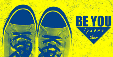 Be you, ignore them phrase on a bright yellow and blue background with cool trainers - inspiration and motivationの写真素材