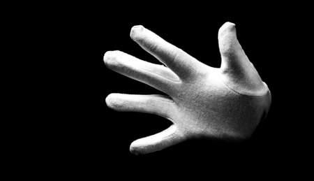 Number five 5 - a male hand wearing white glove isolated on black background. Open hand gesturesの写真素材