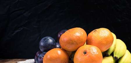 Fresh fruit selection against dark background