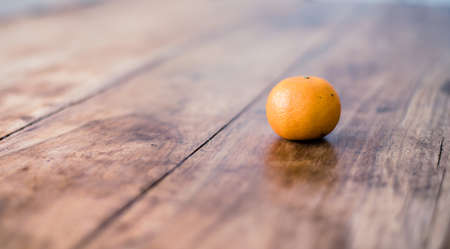 Ripe mandarin isolated on rustic vintage wooden tableの写真素材
