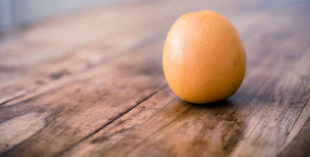 Ripe orange isolated on rustic vintage wooden tableの写真素材
