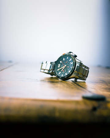 Alloa, Scotland - 17 July 2019 - wrist watch isolated on a wooden background. Accurist man watchのeditorial素材