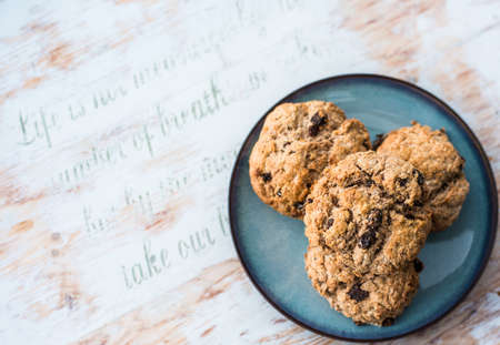 Fruit scones - freshly baked raisins and cinnamon scones on vintage plateの写真素材