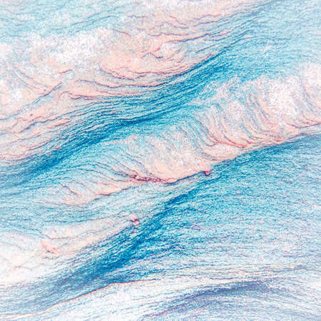 Abstract blue, gray, orange and green background - layers of rocks exposed by sea in Northumberland