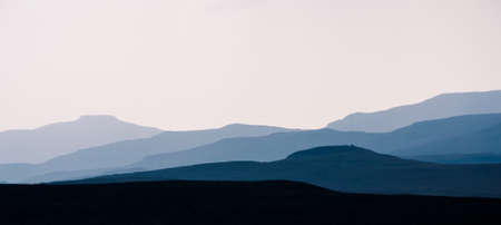 Isle of Skye - misty island landscape - hills silhouette covered in mistの写真素材