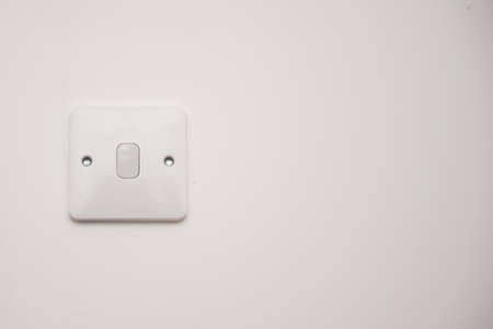 Light switch on a white wall