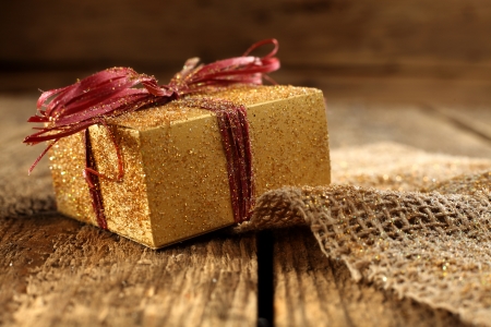 gold present box on rustic tableの写真素材