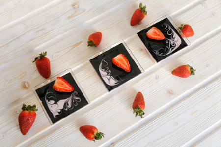 Strawberry tiramisu, trifle, custard dessert in a glass with fresh strawberry and mint leaves on a white background. Dessert, cheesecake, tiramisu with strawberry.の写真素材