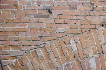 Background of old vintage dirty brick wall with peeling plaster, texture.の写真素材