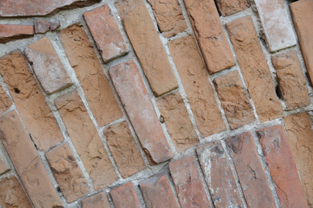 Background of old vintage dirty brick wall with peeling plaster, texture.の写真素材
