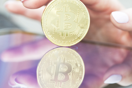 Bitcoin gold coin and defocused chart background.の写真素材