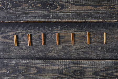 Beautiful Christmas composition in a row on dark wooden background. Flat lay, top viewの写真素材