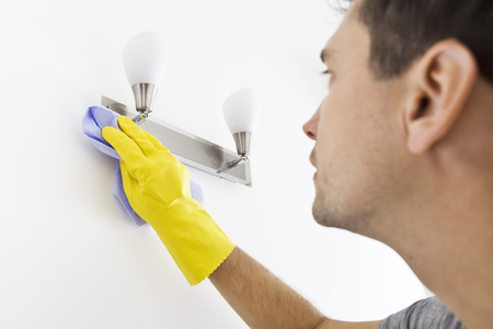 Close up of cleaning young man with yellow protectv glovesの写真素材