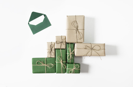 Christmas green and brown gift boxes with letter to Santa on white background. Flat lay, top viewの写真素材