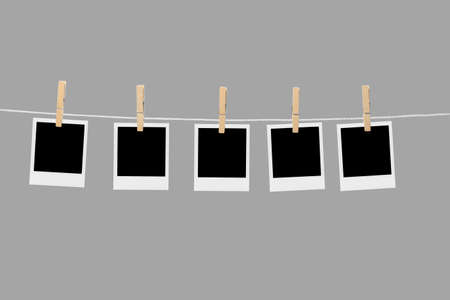 Old picture frame hanging on clothesline on background.