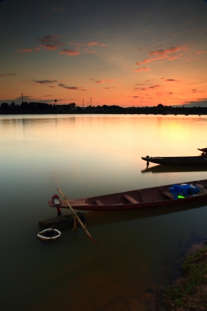 Fishing boat on the âMoon Riverâ in Thailand after sunset.の写真素材