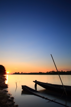 Fishing boat on the âMoon Riverâ in Thailand after sunset.の写真素材