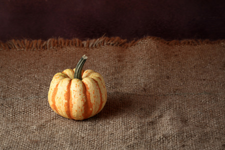 Autumn pumpkins with leaves on wooden boardの写真素材