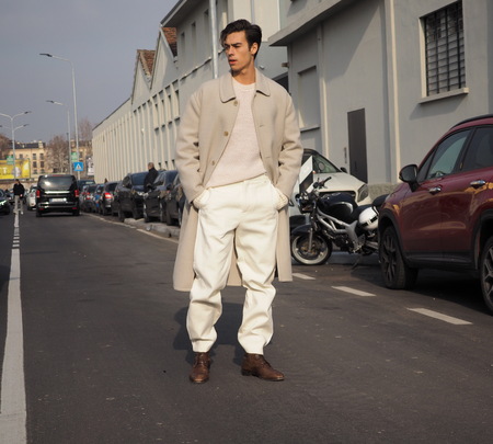 MILAN - JANUARY 14: Young blogger man posing for photographers in the street before DSQUARED2 fashion show, during Milan Fashion Week Man fall / winter 2018/19 on January 14, 2018 in Milan.のeditorial素材
