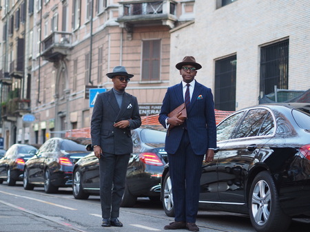 MILAN - January 13: Two fashionable men posing in the street before the NEIL BARRET fashion show, during Milan Fashion Week Fall / Winter 2018/2019. January 13 2018 Milan, Italy.のeditorial素材
