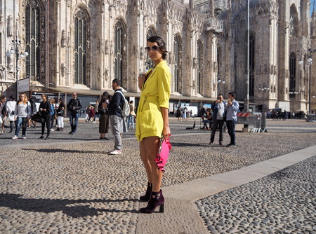 MILAN - SEPTEMBER 21: A fashionable woman in yellow posing for photographers before GENNY fashion show, during Milan Fashion Week spring / summer 2018 on September 21, 2017 in Milan.のeditorial素材