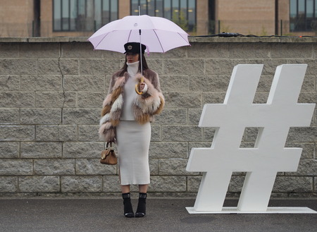 MILAN - FEBRUARY 22, 2018: Fashionable woman posing for photographers in the street before LES COPINS fashion show, during Milan Fashion Week Woman fall / winter 2018/19 February 2018 in Milan, Italy.のeditorial素材