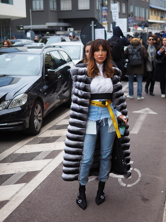 MILAN - FEBRUARY 25, 2018: Fashionable woman posing for photographers in the street after TRUSSARDI fashion show, during Milan Fashion Week Woman falling / winter 2018/19 in Milan, Italy.のeditorial素材