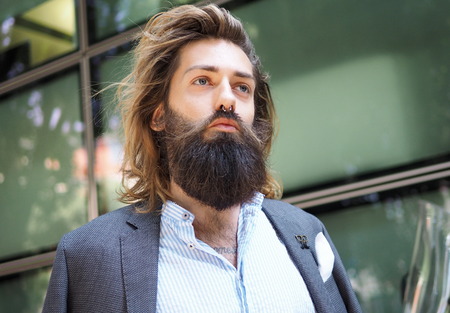 MILAN, ITALY -JUNE 18, 2018: Fashionable man posing for photographers in the street before GIORGIO ARMANI fashion show, during Milan Fashion Week Men and women spring collections.のeditorial素材
