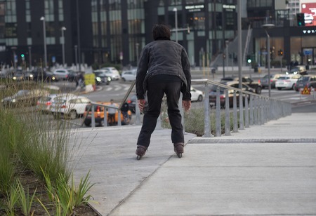 MILAN, Italy: 25 November 2018: Reckless roller skate boy on railing in new park "Library of the Trees" in Porta Nuova Milan, Lombardy,のeditorial素材