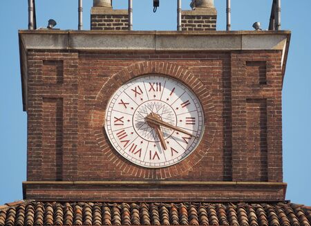 Historic big clock on the entrance of the University in Milan.の写真素材