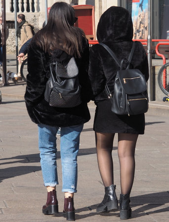 Couple walking in duomo square, Milan, Italy