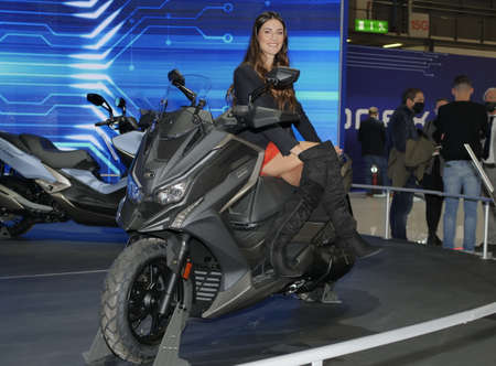 Girls, Motorbikes and accessories exposed at EICMA, international motorcycle exhibition, Lombardy,...
