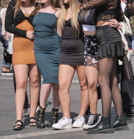 Girls in miniskirts and pantyhose, posing for photographers in Duomo square, Milan, Italyの写真素材