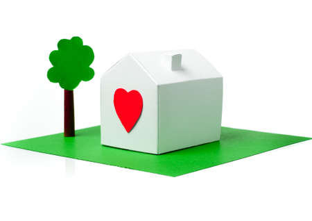 White paper house with a red heart on surfaceの写真素材