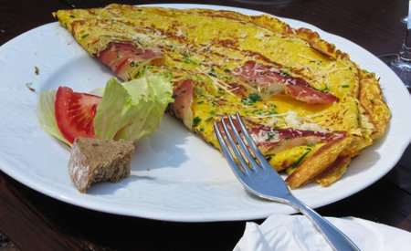 Omelet with speck, cheese and herbsの写真素材